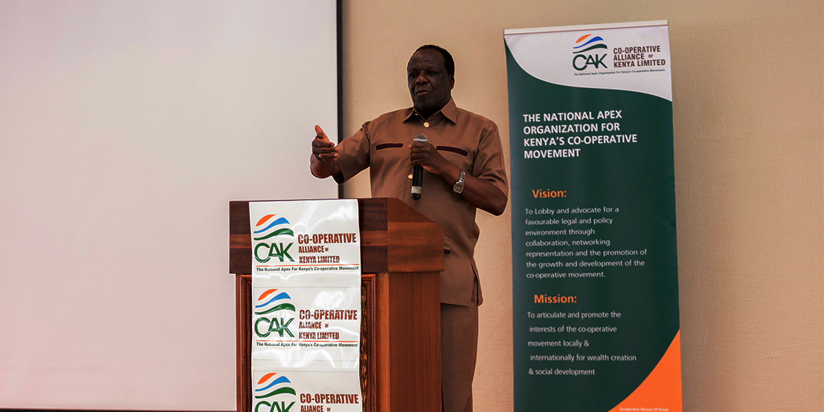 CS for Cooperatives Wycliffe Oparanya  delivering a speech at the 3rd Annual Cabinet Secretary Forum for the Ministry of Cooperatives and MSMEs engaging with stakeholders in the cooperative movem.png